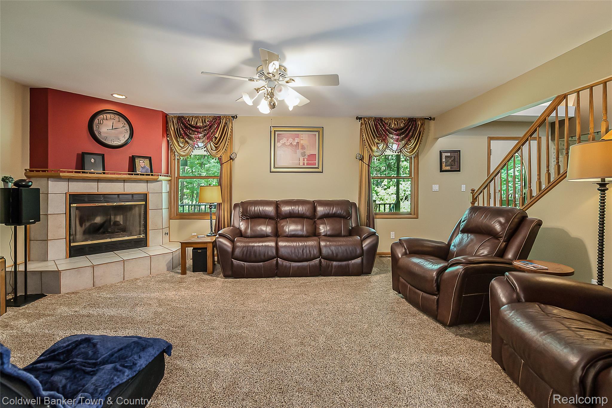 11527 Mcgregor Road Pinckney, MI 48169 - Photo 5 of 26 Carpeted living room with plenty of natural light, stairway, a fireplace, and ceiling fan