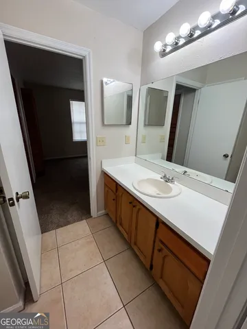 a bathroom with a double vanity sink and a mirror