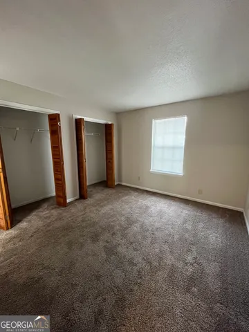 an empty room with a empty space and windows