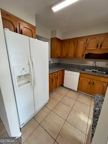 a kitchen with stainless steel appliances a refrigerator and a sink