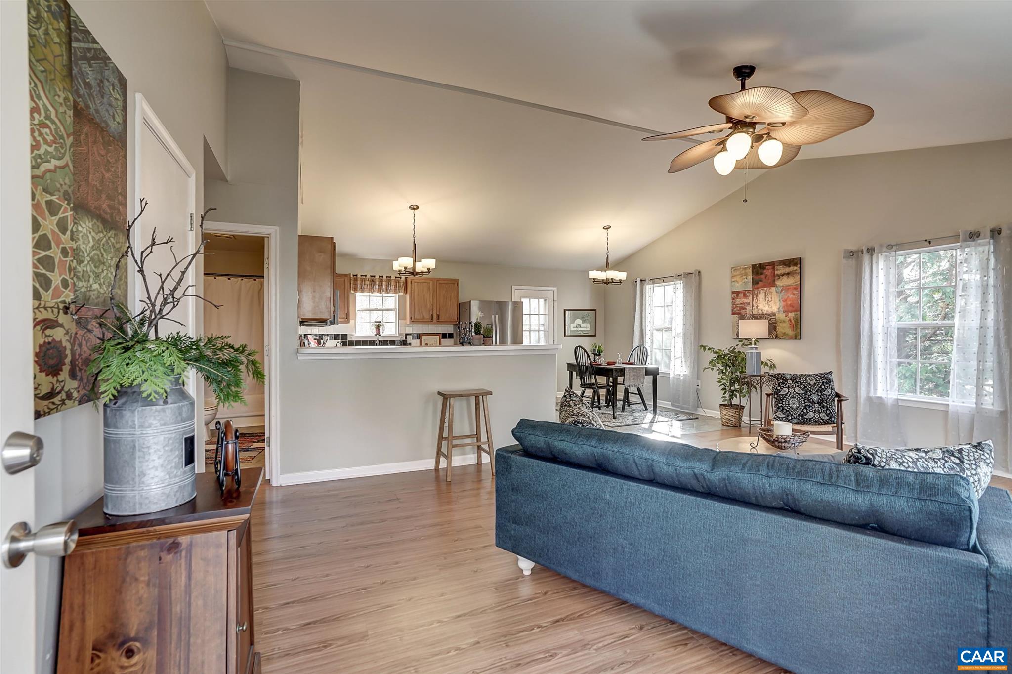 455 Jonquil Road Ruckersville, VA 22968 - Photo 8 of 23 a living room with kitchen island furniture and a chandelier