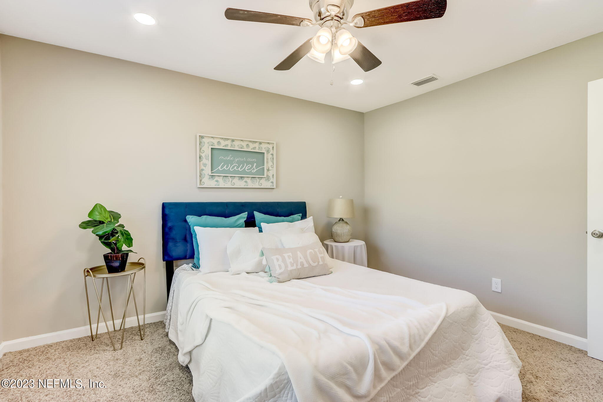 8545 Laurens Road Jacksonville, FL 32208 - Photo 17 of 29 a bedroom with a bed and a chandelier
