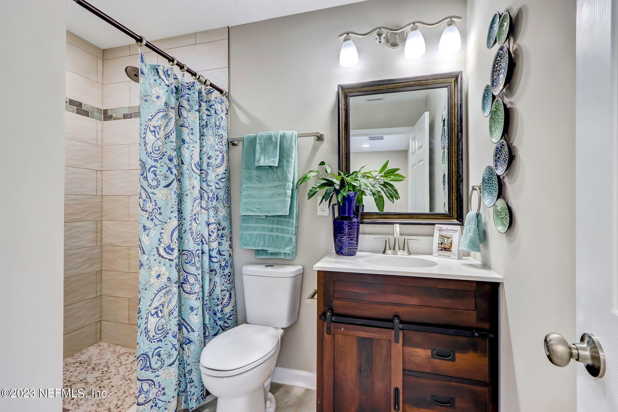 8545 Laurens Road Jacksonville, FL 32208 - Photo 19 of 29 a bathroom with a sink toilet and shower