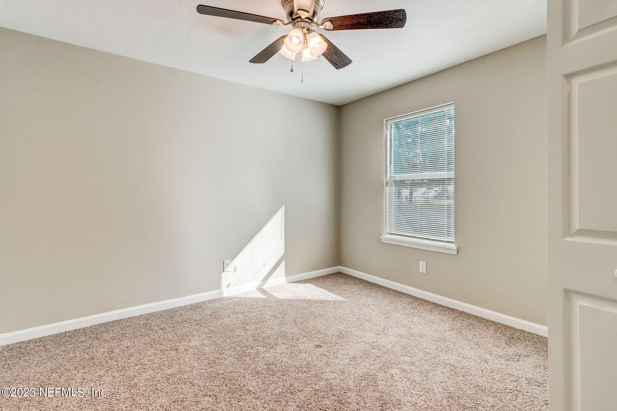8545 Laurens Road Jacksonville, FL 32208 - Photo 21 of 29 an empty room with windows and fan