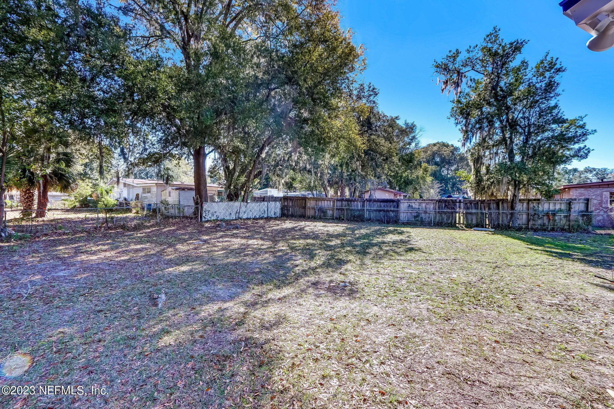 8545 Laurens Road Jacksonville, FL 32208 - Photo 25 of 29 a view of yard with tree and wooden fence