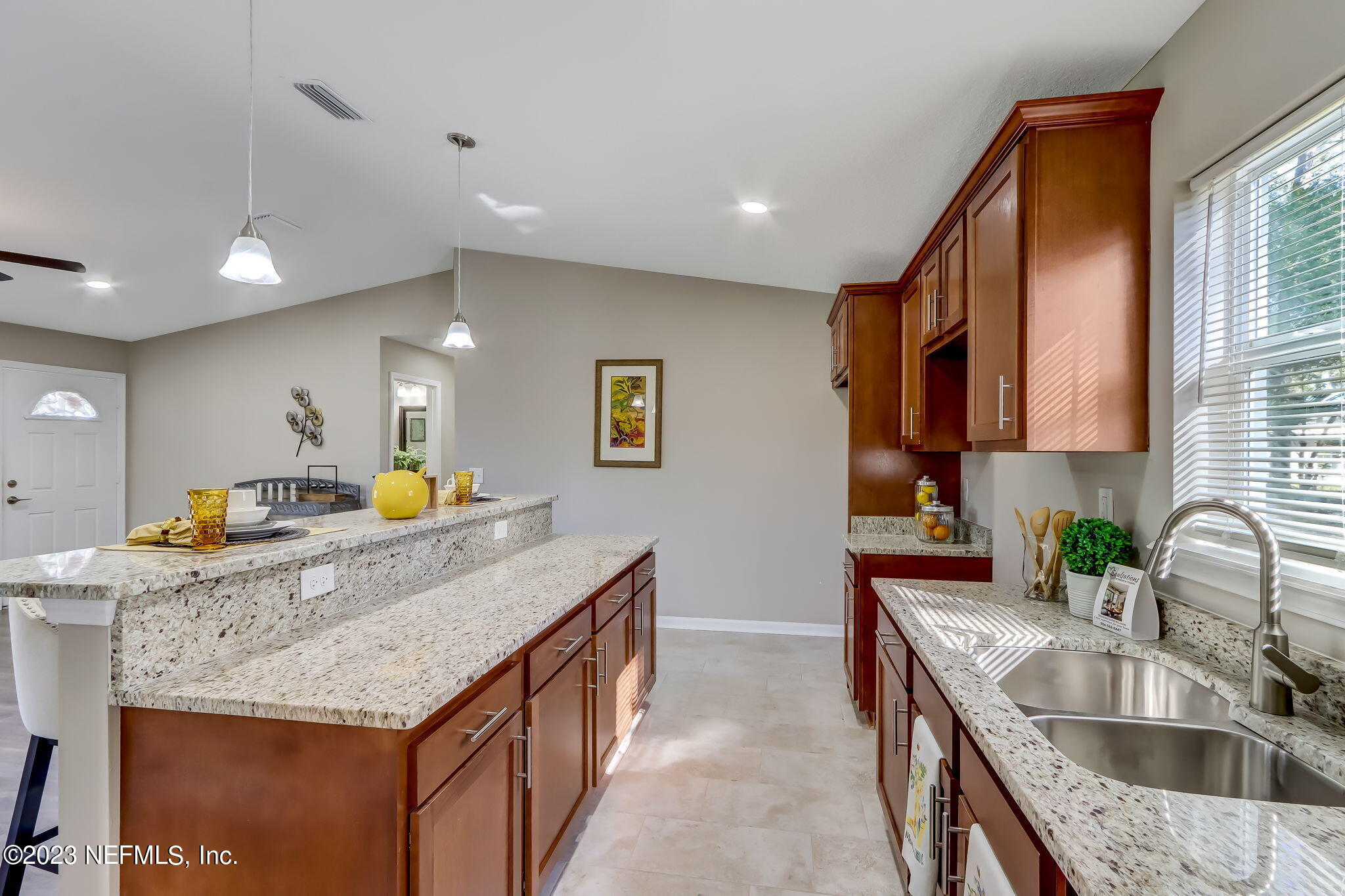 8545 Laurens Road Jacksonville, FL 32208 - Photo 9 of 29 a kitchen with stainless steel appliances granite countertop a sink a stove and a wooden cabinets