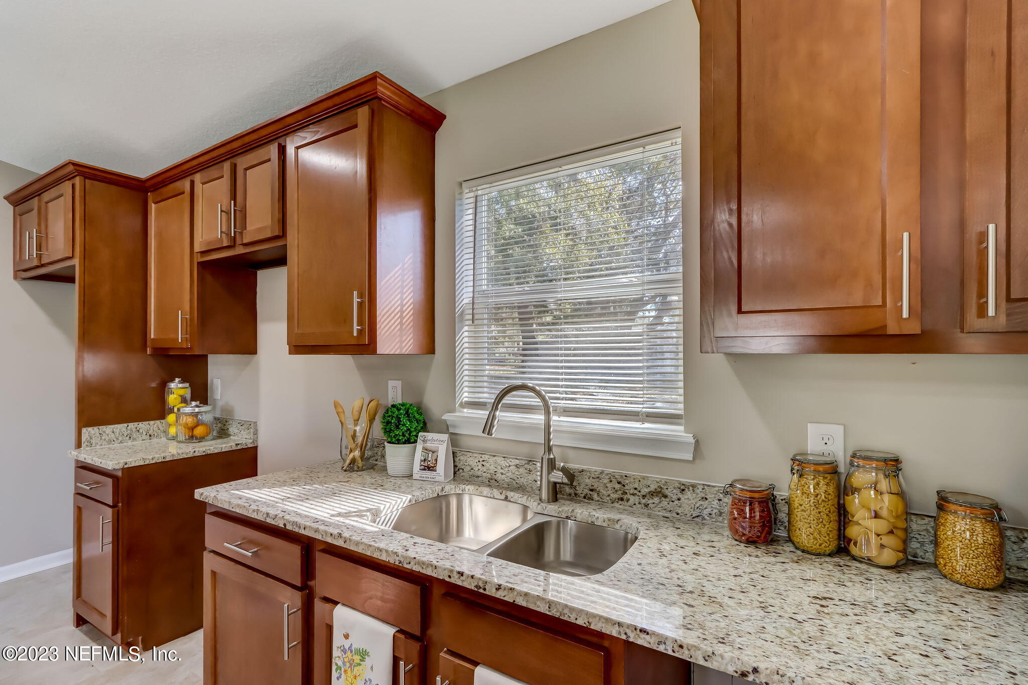 8545 Laurens Road Jacksonville, FL 32208 - Photo 10 of 29 a kitchen with sink a window and cabinets