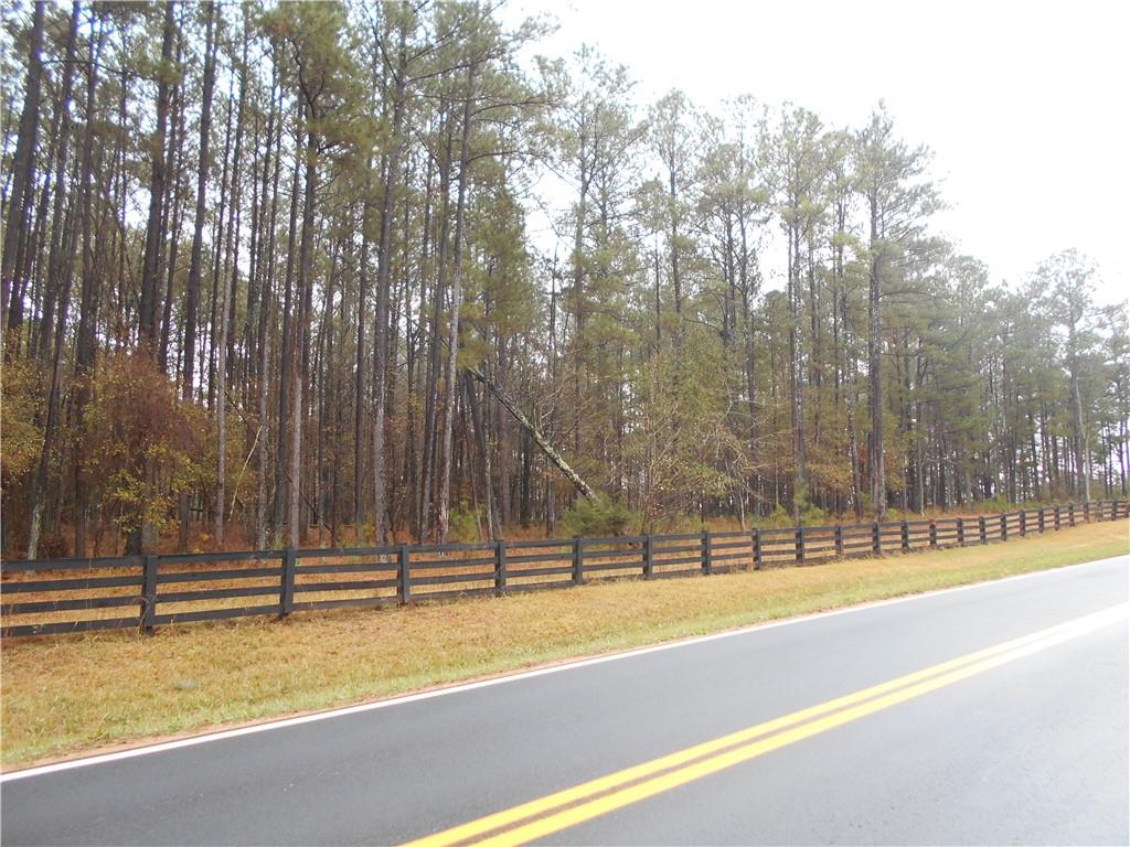 7-ac Youth Jersey Road Covington, GA 30014 - Photo 6 of 34 a view of a swimming pool with a patio and a yard with trees