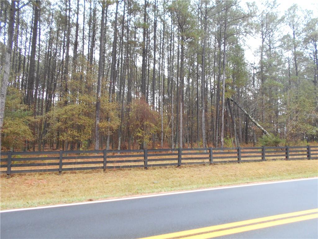 7-ac Youth Jersey Road Covington, GA 30014 - Photo 8 of 34 a view of a swimming pool with a house in the background