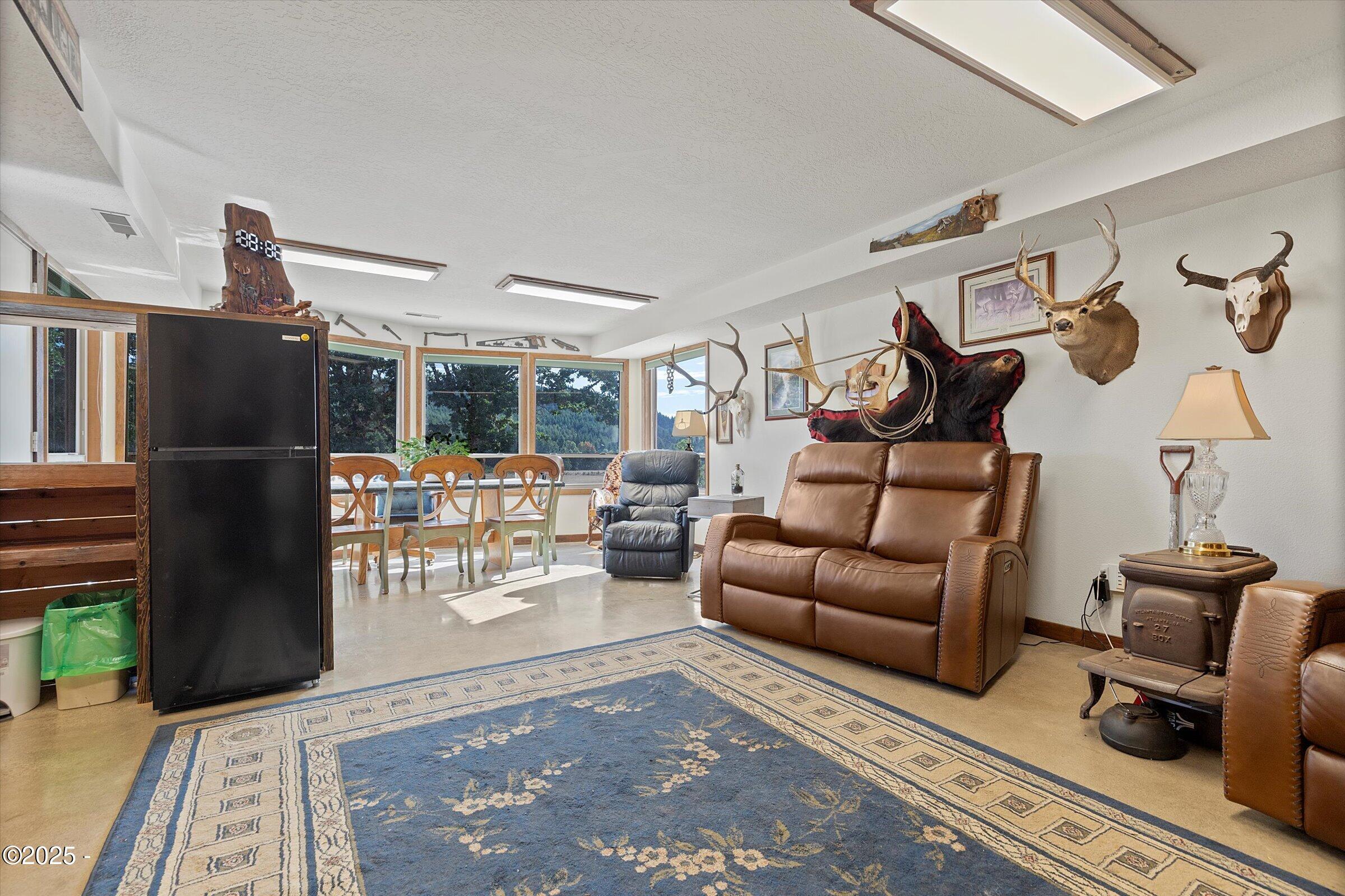 21560 Gooseneck Road Sheridan, OR 97378 - Photo 43 of 63 a living room with furniture a wooden floor and a fireplace