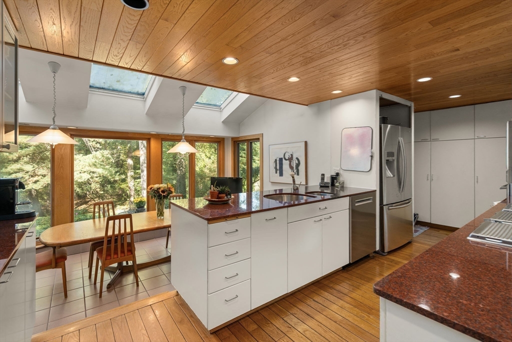 60 Possum Road Weston, MA 02493 - Photo 4 of 21 a kitchen with a sink appliances cabinets and dining table