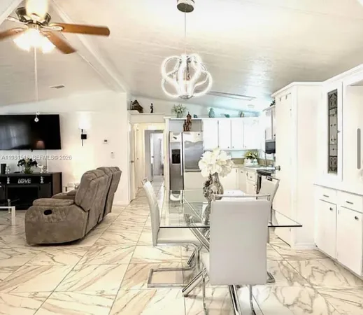a living room with fireplace furniture and a chandelier