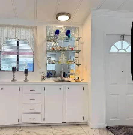 a kitchen with cabinets and window