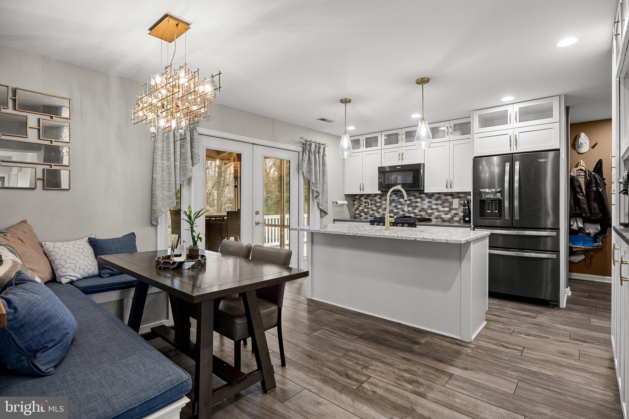 4 Mill Run Court Medford, NJ 08055 - Photo 9 of 53 a kitchen with stainless steel appliances kitchen island granite countertop a table chairs stove and refrigerator