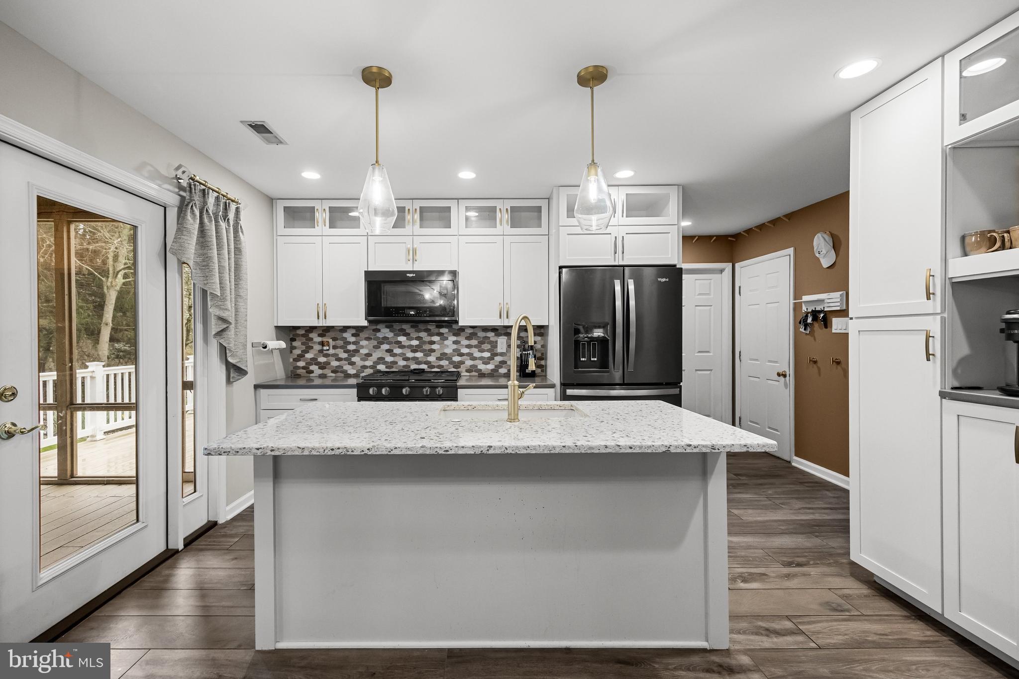 4 Mill Run Court Medford, NJ 08055 - Photo 10 of 53 a large kitchen with stainless steel appliances kitchen island granite countertop a refrigerator a oven and white cabinets with wooden floor