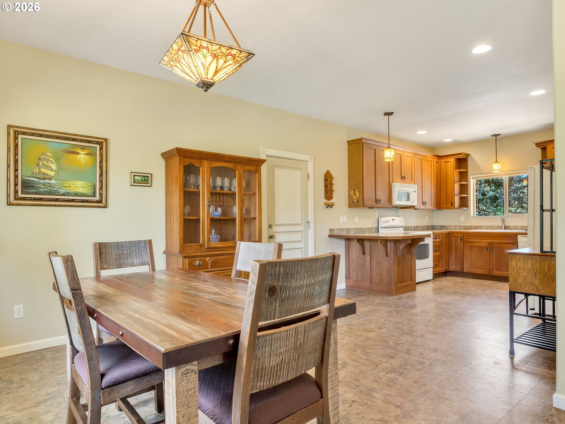 1077 Southwest Ridge Road Warrenton, OR 97146 - Photo 26 of 46 a view of a dining room with furniture and wooden floor
