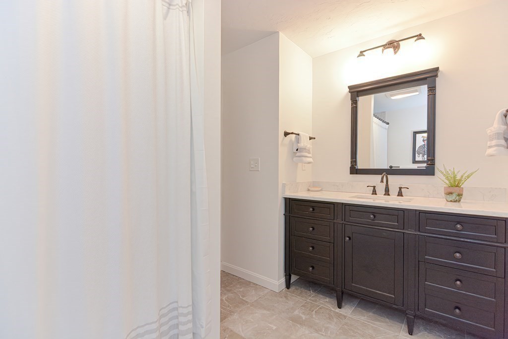 40 Wadsworth Road Ashland, MA 01721 - Photo 24 of 42 a bathroom with a double vanity sink and a mirror
