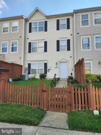 a front view of house with a garden
