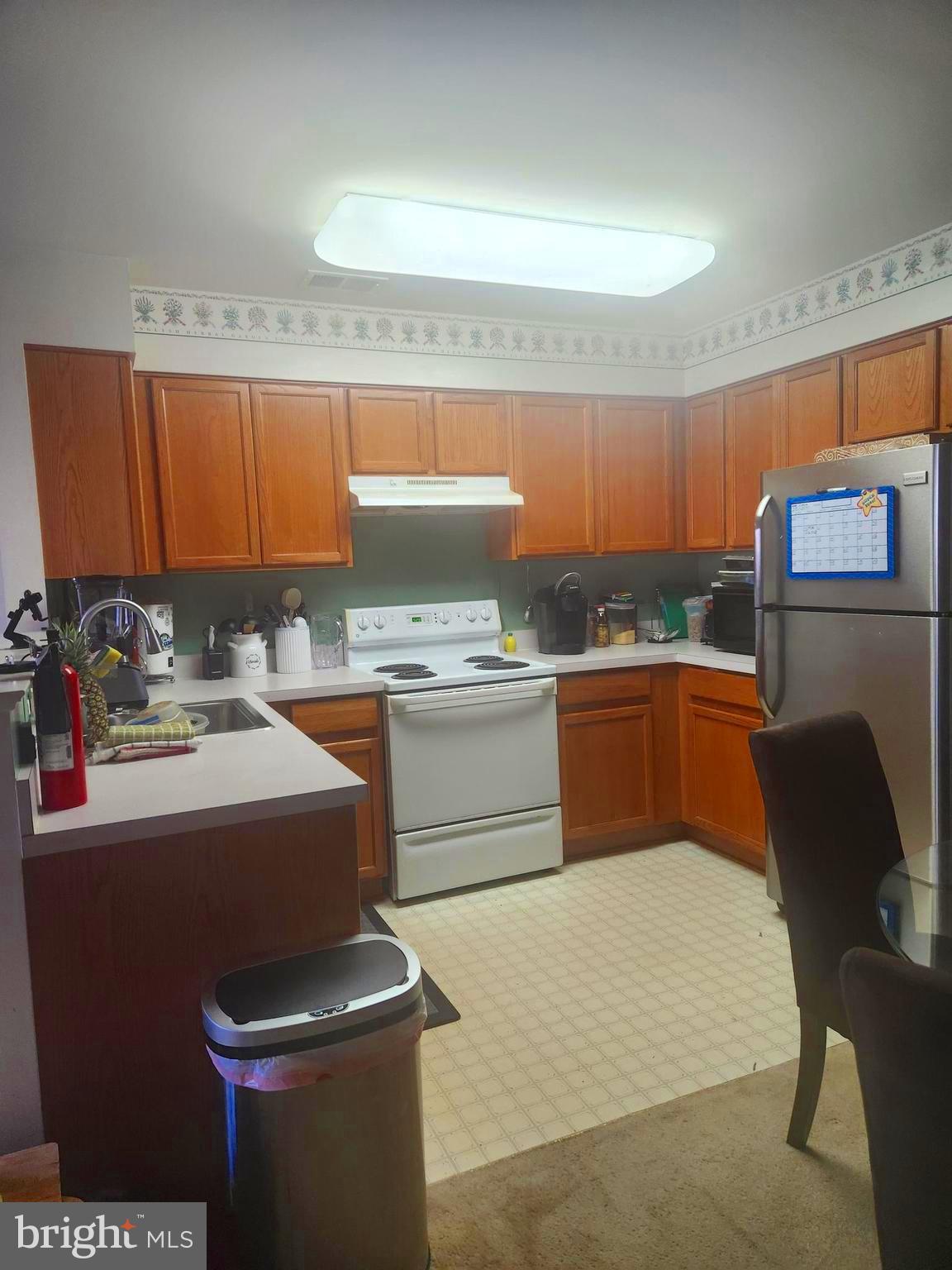 5086 Stapleton Terrace Frederick, MD 21703 - Photo 2 of 24 a kitchen with a sink a stove and chairs