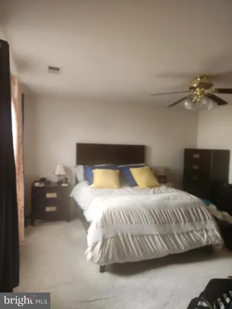a bedroom with a bed and a night stand