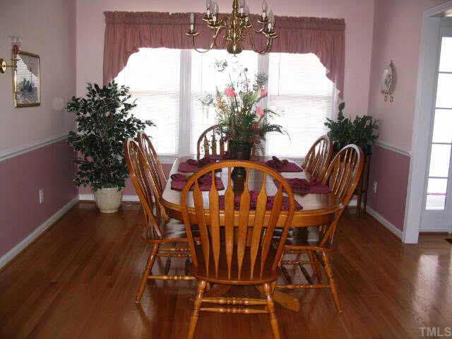 1017 Linden Crest Road Raleigh, NC 27603 - Photo 6 of 10 a view of a dining room with furniture and wooden floor
