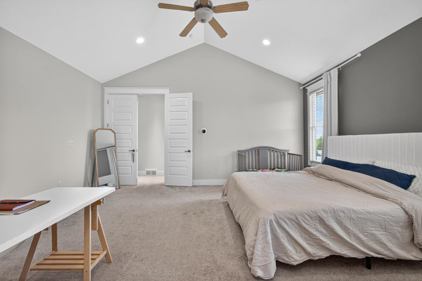 5700 Emily Road Bettendorf, IA 52722 - Photo 33 of 58 a spacious bedroom with a bed and a table