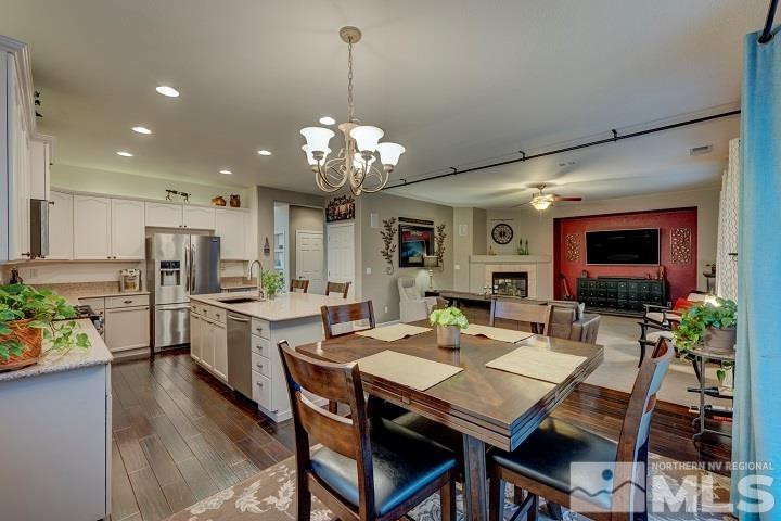 10520 Baton Court Reno, NV 89521 - Photo 15 of 38 a view of a dining room and livingroom with furniture wooden floor a chandelier