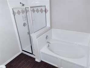 a bathroom with a bathtub and a shower