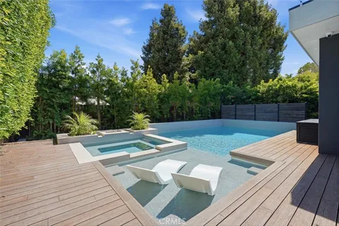 a view of a chairs and tables in the backyard