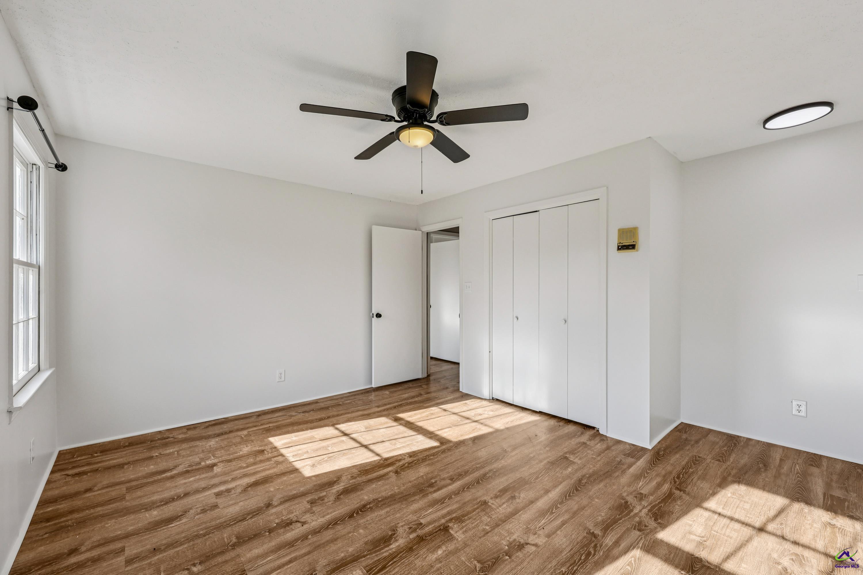 548 Greene Settlement Road Gray, GA 31032 - Photo 29 of 68 a view of empty room with wooden floor and ceiling fan