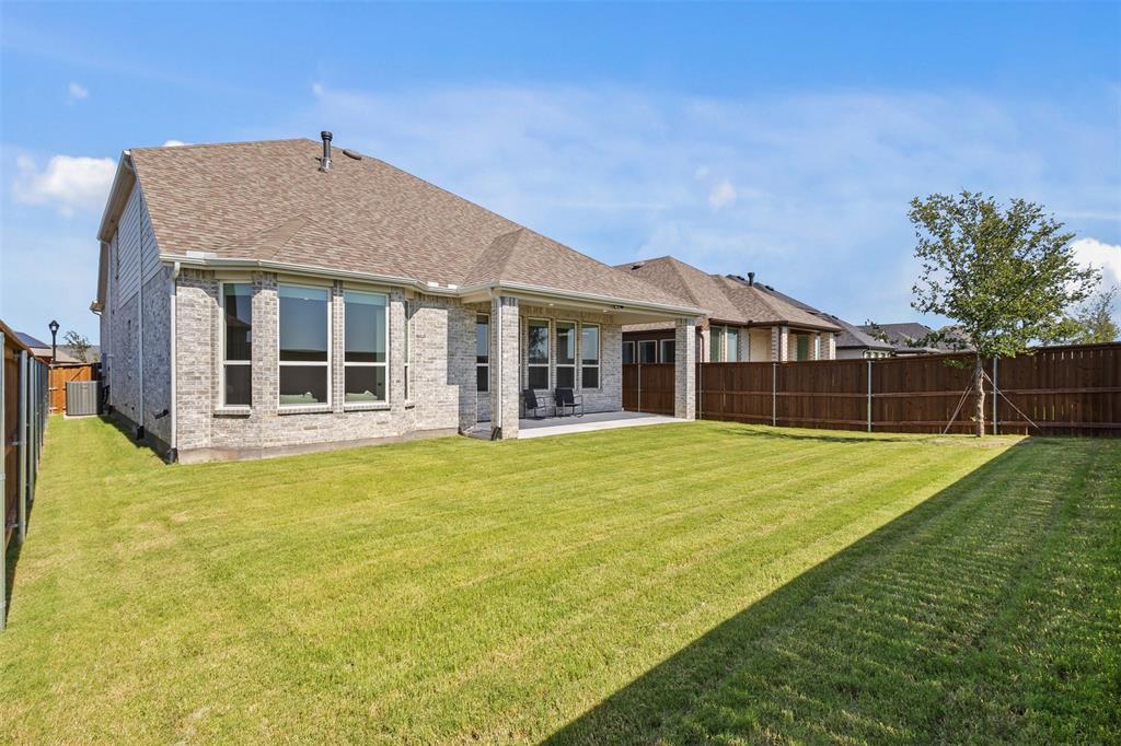 1825 Rough Rdg Trail Midlothian, TX 76065 - Photo 32 of 37 Expansive green lawn with a brown privacy fence