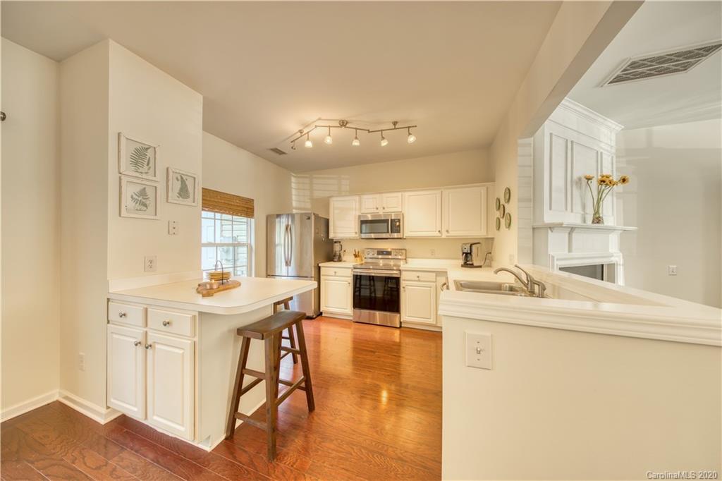 6921 Rothchild Drive Charlotte, NC 28270 - Photo 13 of 26 a kitchen with a sink a stove a refrigerator and white cabinets