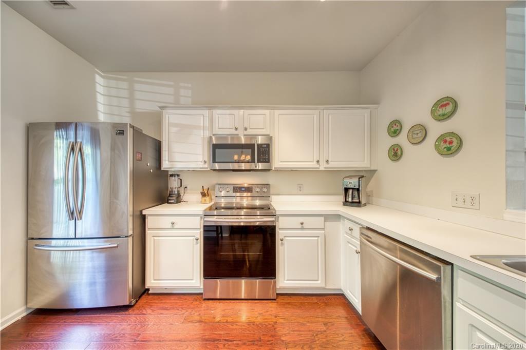 6921 Rothchild Drive Charlotte, NC 28270 - Photo 14 of 26 a kitchen with stainless steel appliances a stove a sink and a refrigerator
