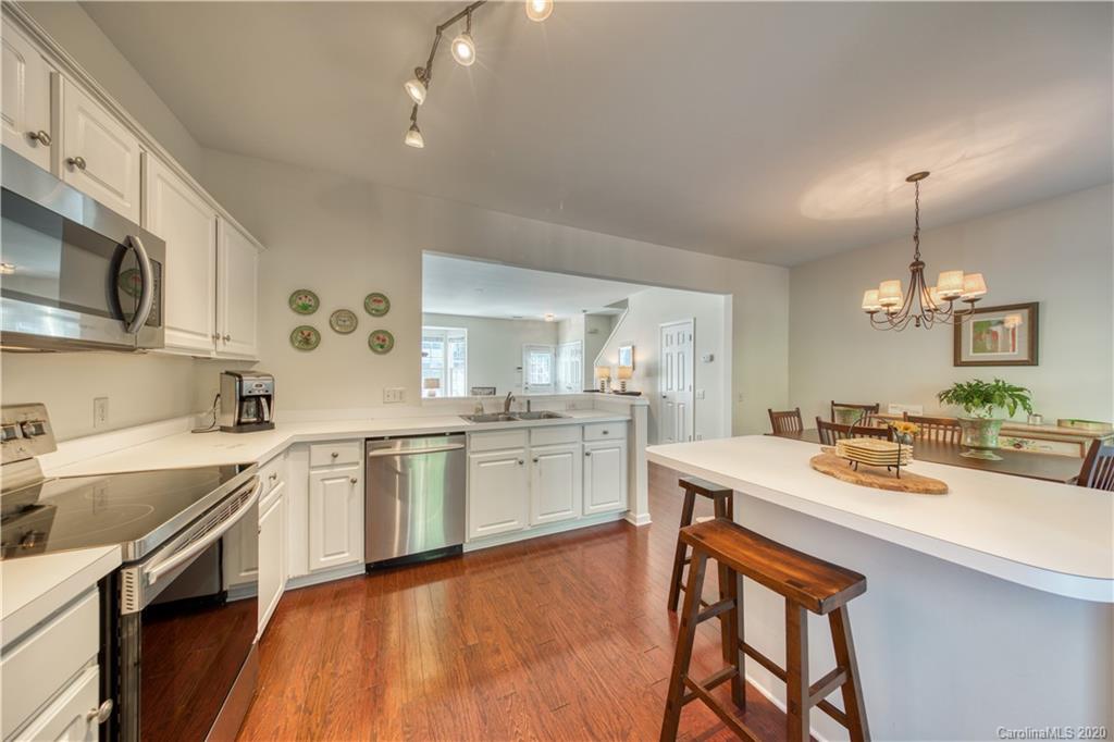 6921 Rothchild Drive Charlotte, NC 28270 - Photo 15 of 26 a kitchen with a sink stove cabinets and wooden floor