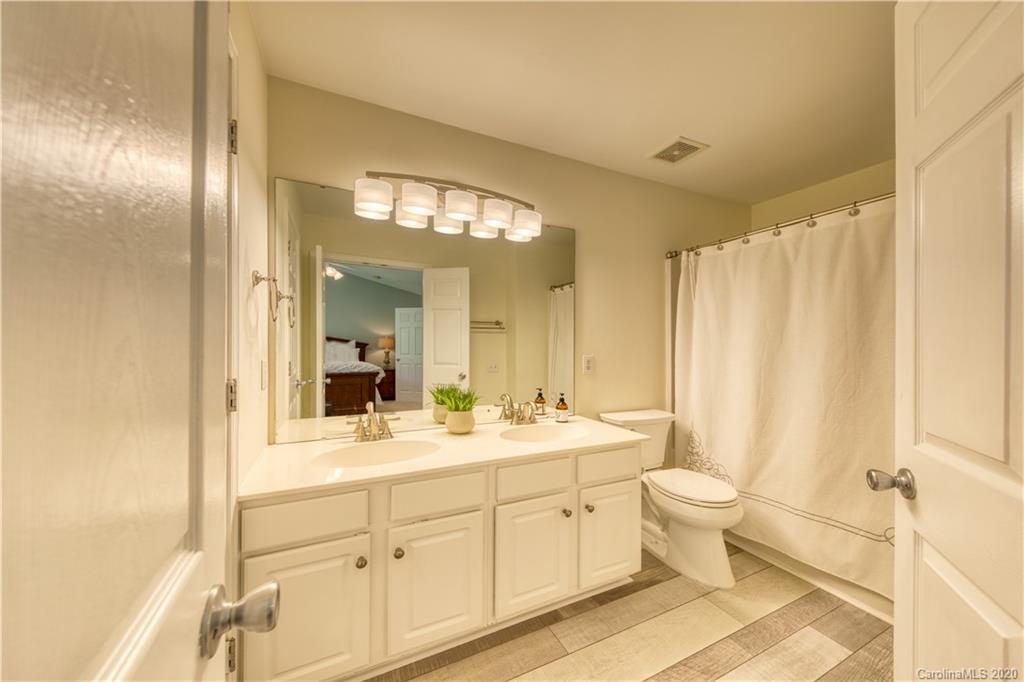 6921 Rothchild Drive Charlotte, NC 28270 - Photo 19 of 26 a spacious bathroom with a double vanity sink a mirror and a shower