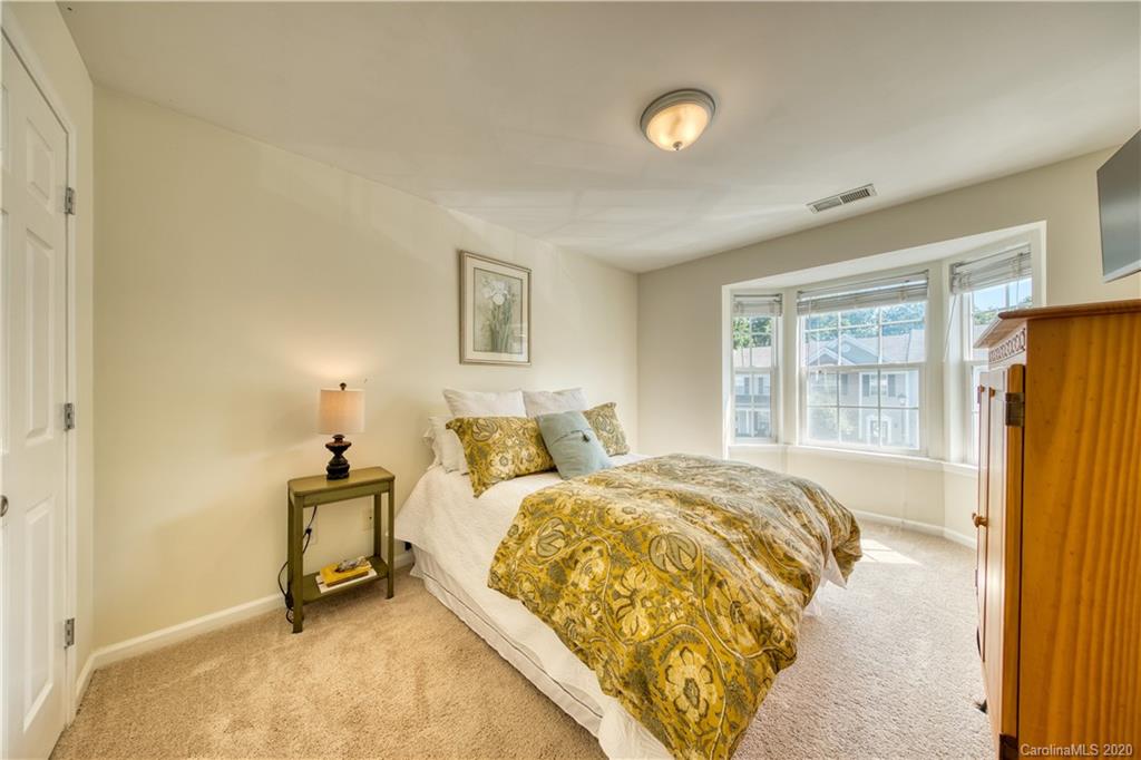 6921 Rothchild Drive Charlotte, NC 28270 - Photo 21 of 26 a bedroom with a bed and a window