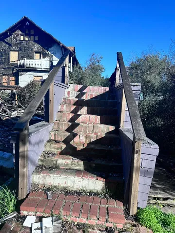 a view of a pathway of a house with wooden stairs