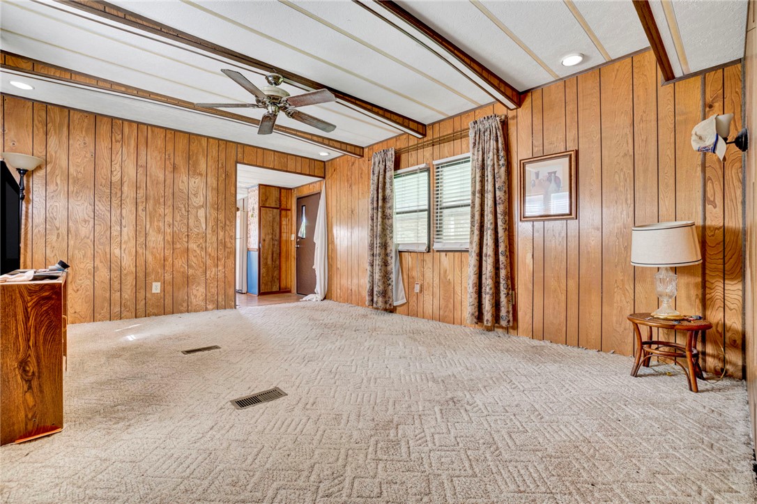 1504 Park Ridge Drive Seneca, SC 29672 - Photo 10 of 16 Rich wood paneling and textured carpeting create a warm, classic atmosphere in this inviting living area.