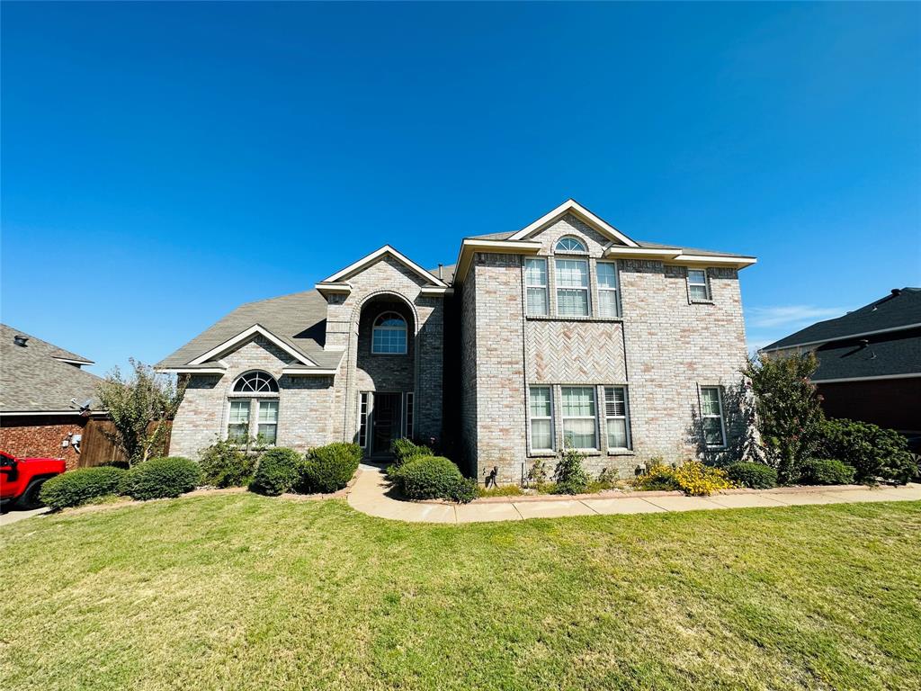 1209 Clearbrook Drive Kennedale, TX 76060 - Photo 1 of 1 a front view of a house with a yard and garage