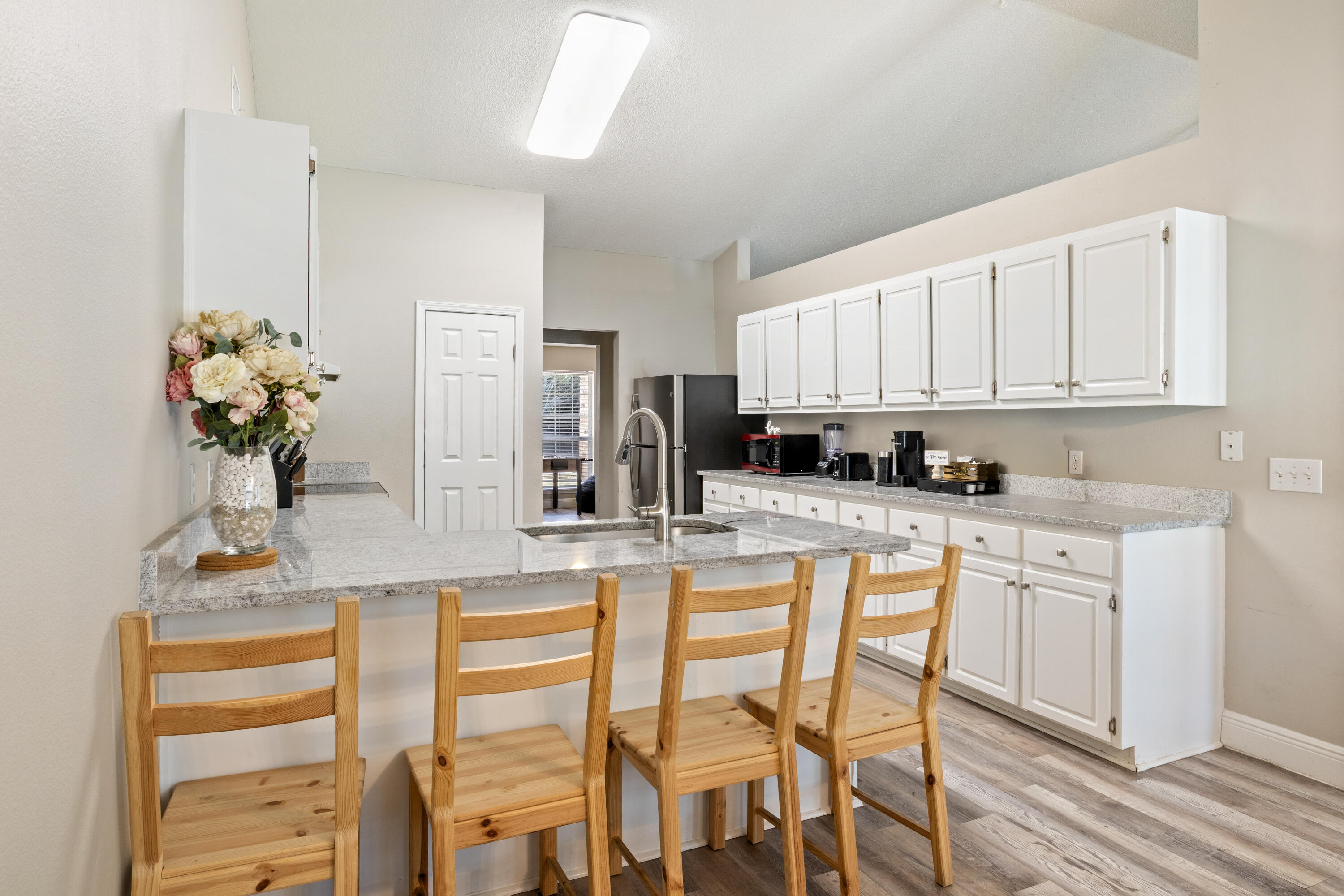 2005 Cardinal Lane Navarre, FL 32566 - Photo 11 of 37 a kitchen with stainless steel appliances granite countertop a kitchen island and chairs in it
