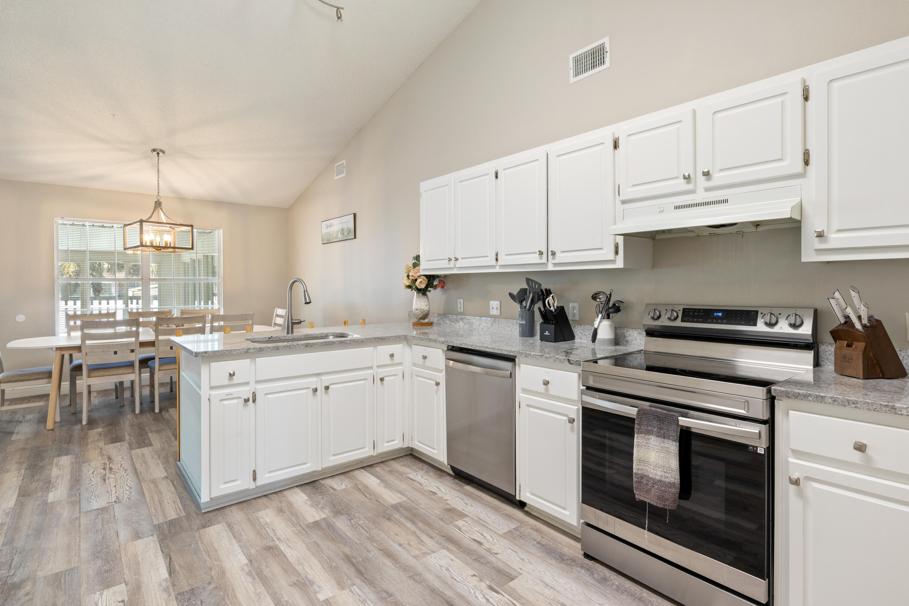 2005 Cardinal Lane Navarre, FL 32566 - Photo 12 of 37 a kitchen with granite countertop white cabinets and white appliances