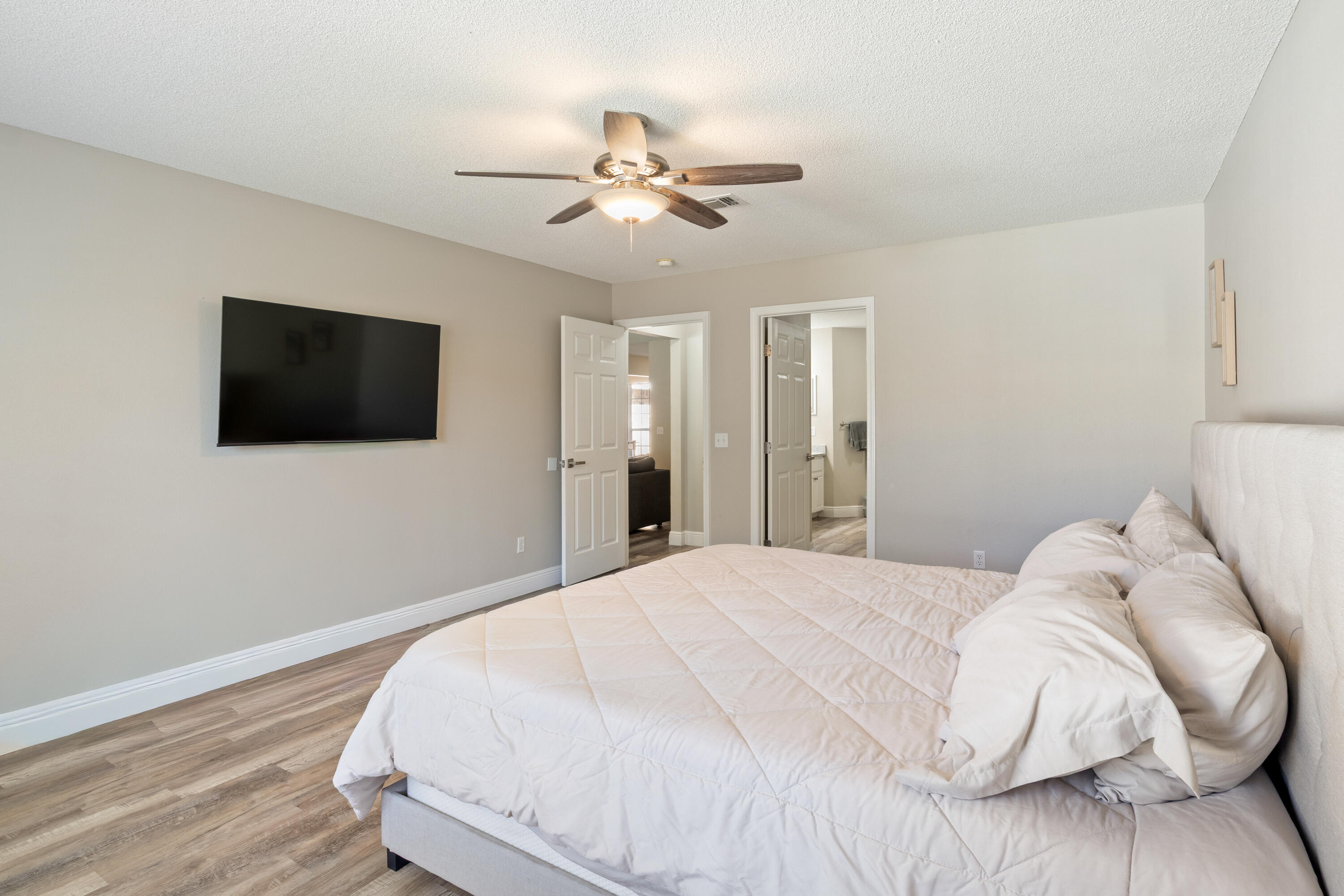 2005 Cardinal Lane Navarre, FL 32566 - Photo 15 of 37 a bedroom with a bed tv and a chandelier