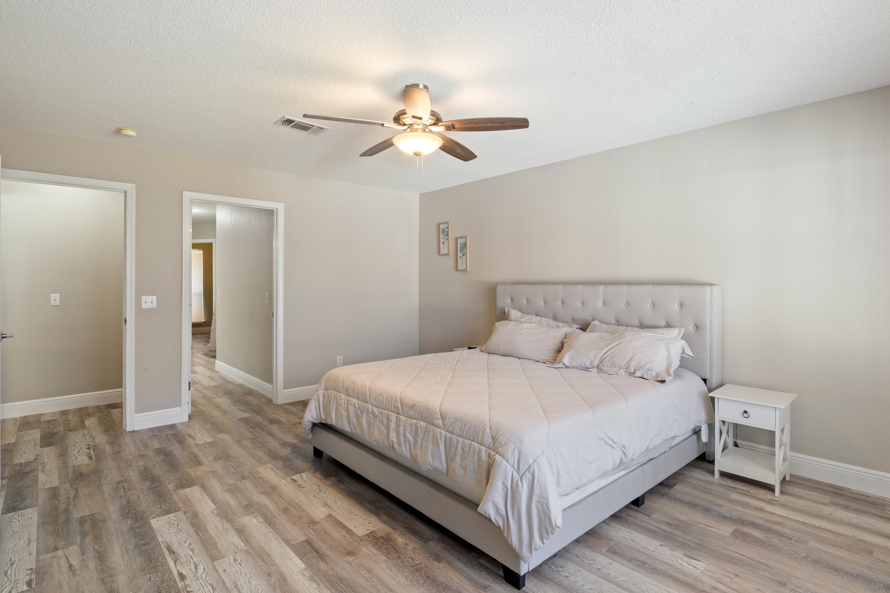 2005 Cardinal Lane Navarre, FL 32566 - Photo 16 of 37 a bedroom with a bed and a chandelier