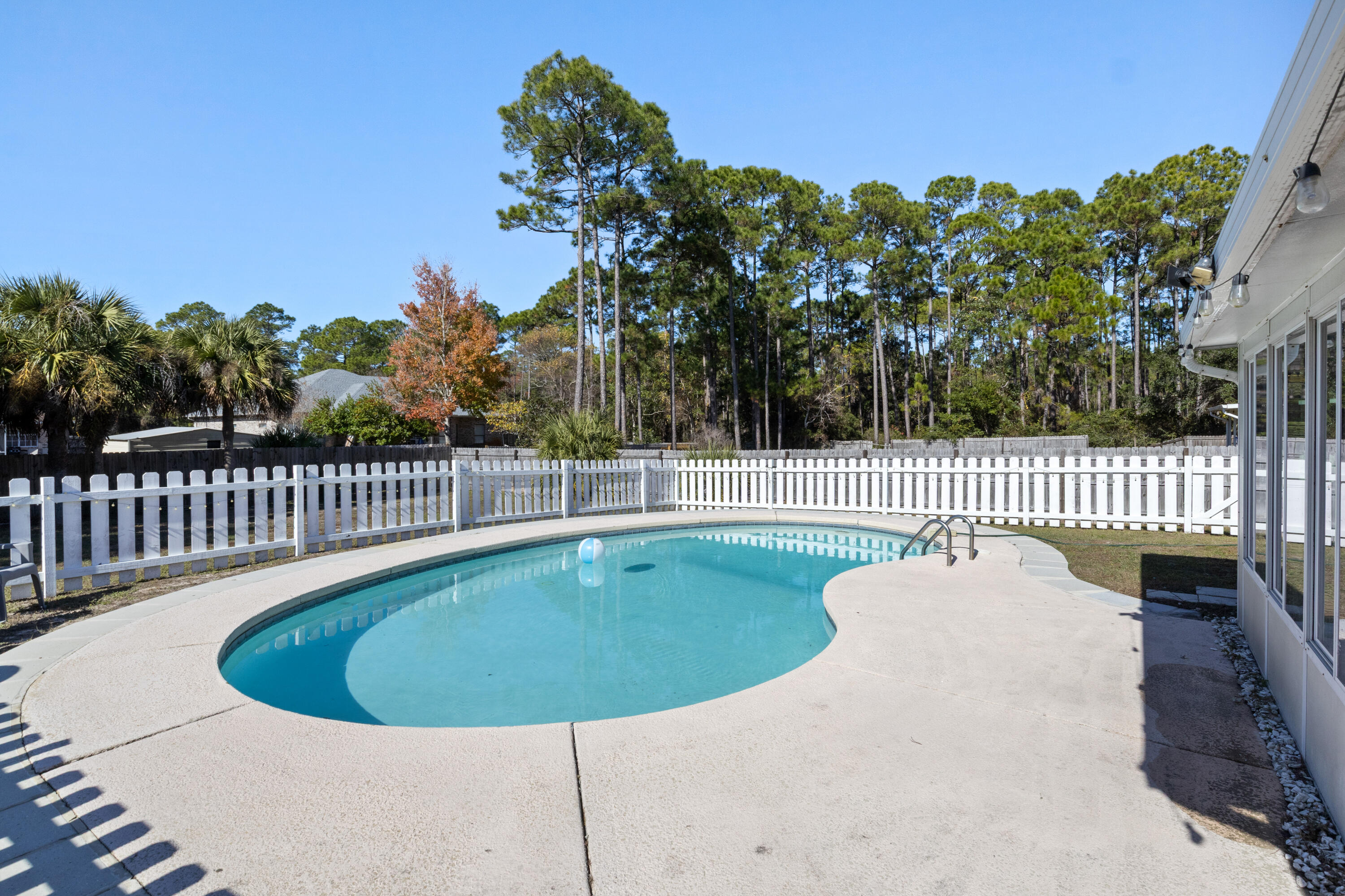 2005 Cardinal Lane Navarre, FL 32566 - Photo 28 of 37 a view of a swimming pool with a porch