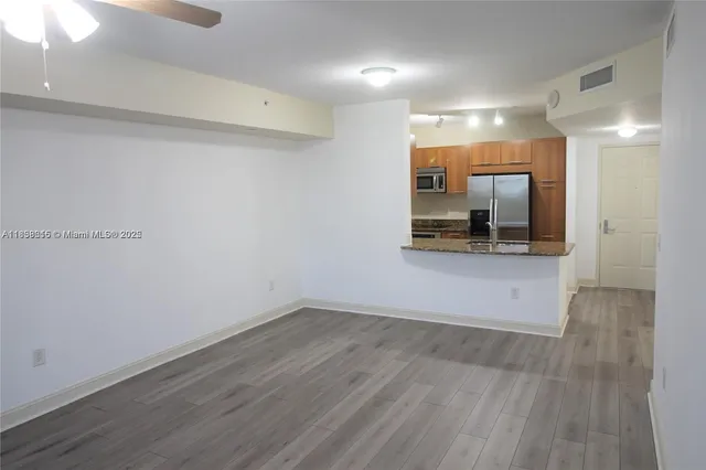 a view of a kitchen with a sink and a mirror
