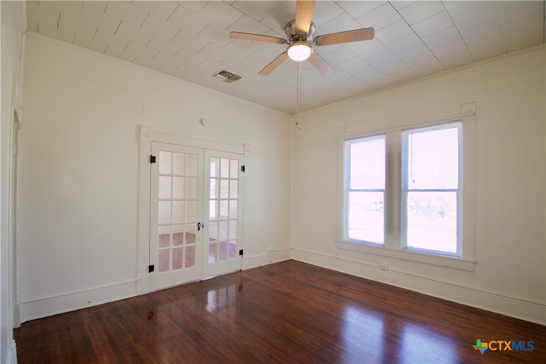 617 North 6th Street Temple, TX 76501 - Photo 12 of 38 an empty room with wooden floor fan and windows