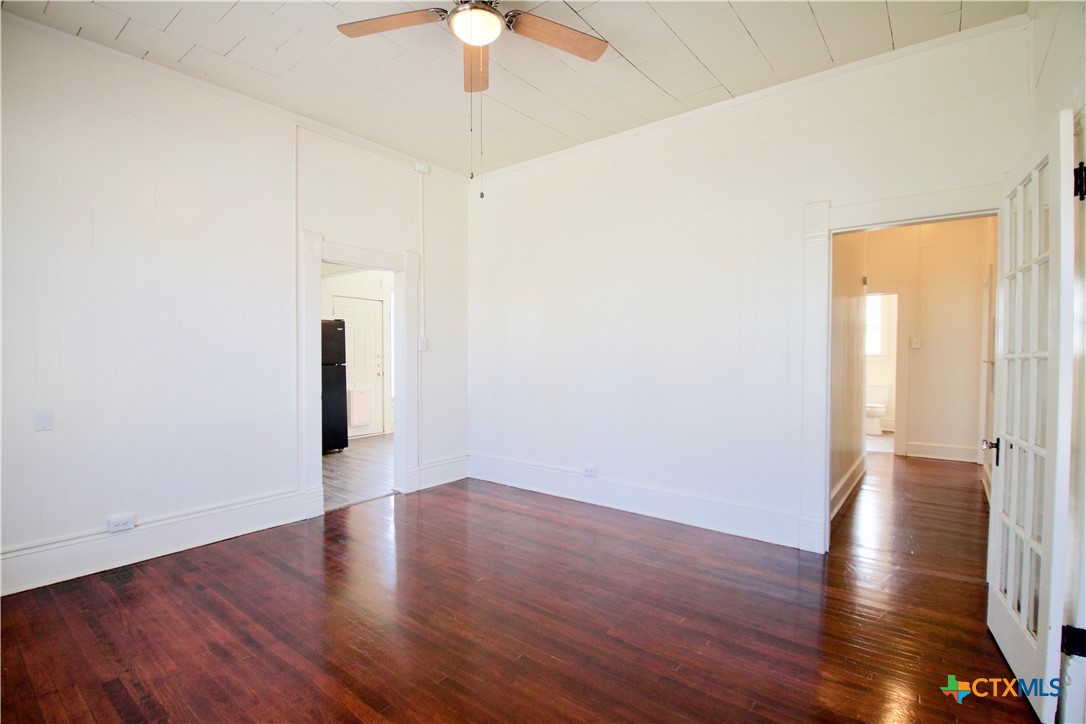 617 North 6th Street Temple, TX 76501 - Photo 14 of 38 a view of a room with wooden floor and a ceiling fan