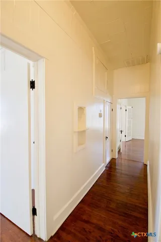 a view of a room with wooden floor