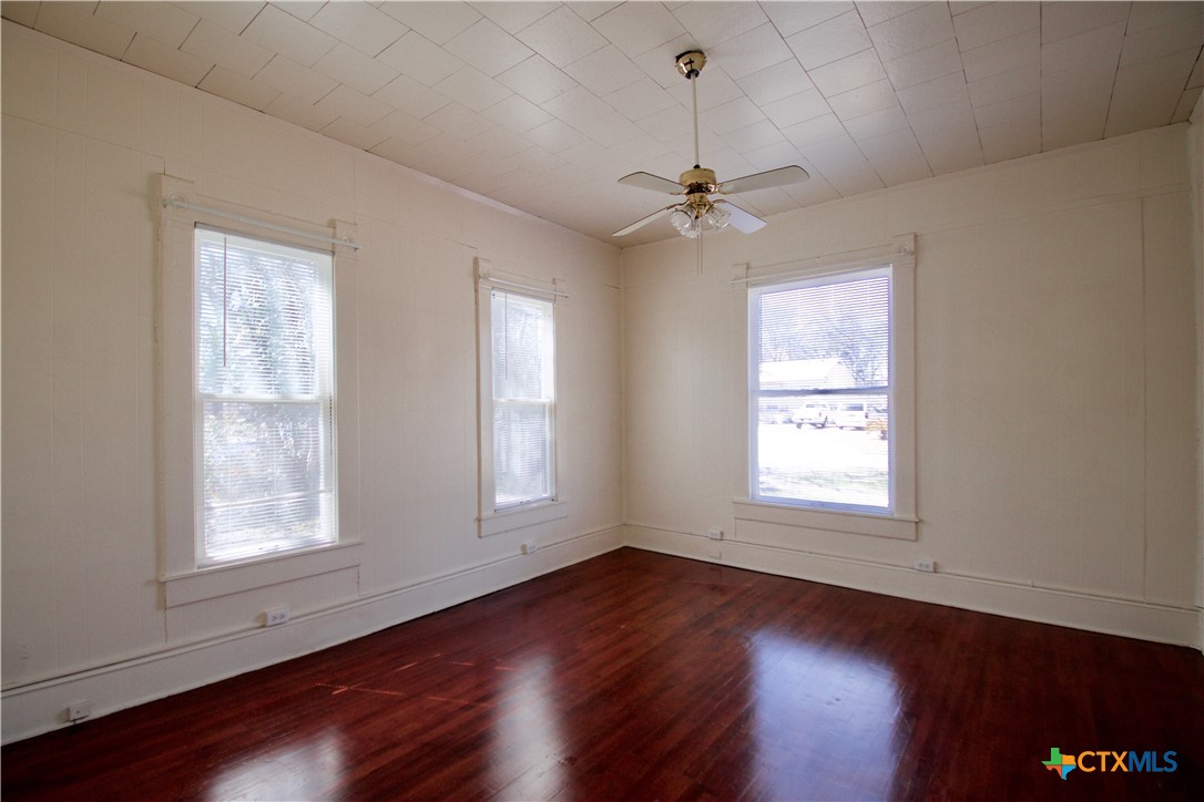 617 North 6th Street Temple, TX 76501 - Photo 19 of 38 a view of an empty room with wooden floor and a window