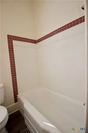 a bathroom with a bathtub and a toilet